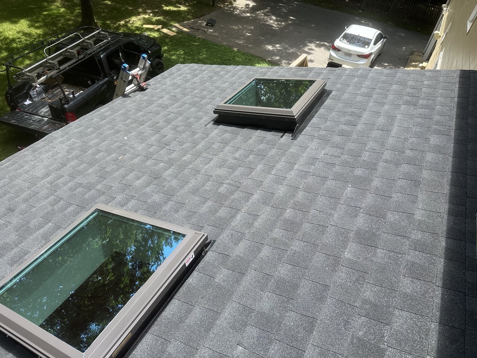 Two skylights installed on a new charcoal shingle roof on a home in the Richmond, VA area