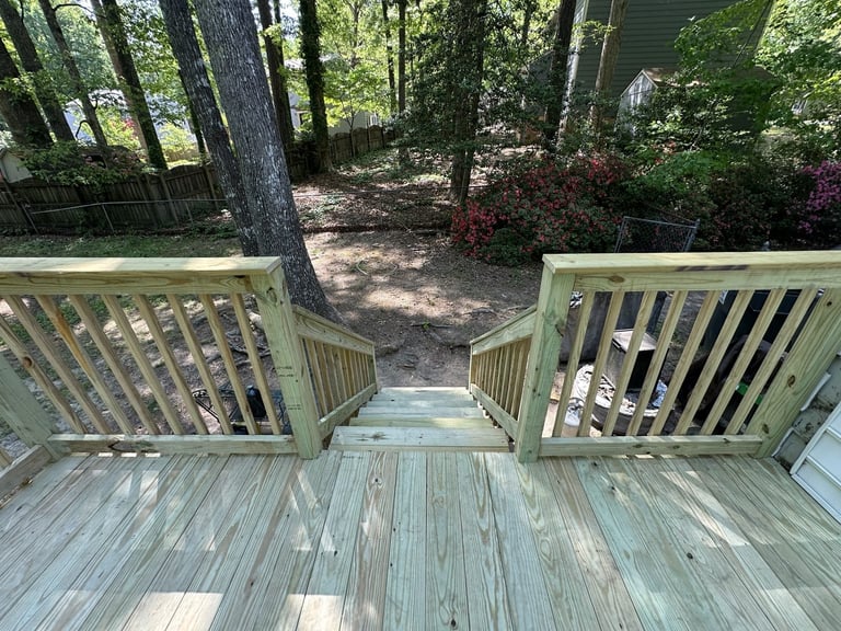 Wooden deck with dual gates opening to a wooded path surrounded by trees, Richmond VA area