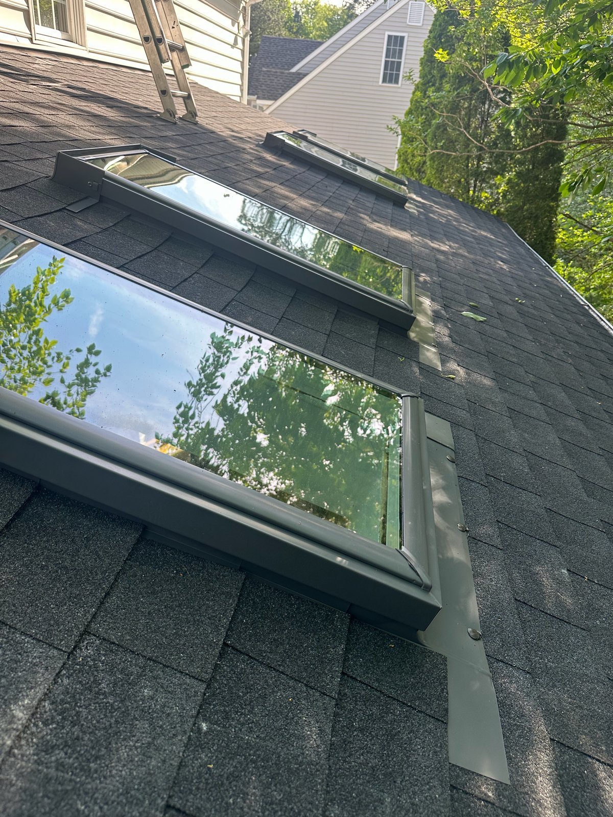 Close-up of skylights with step flashing on a shingle roof