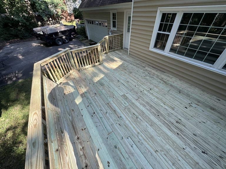 New wooden deck with railings attached to a house with large windows, Richmond VA area